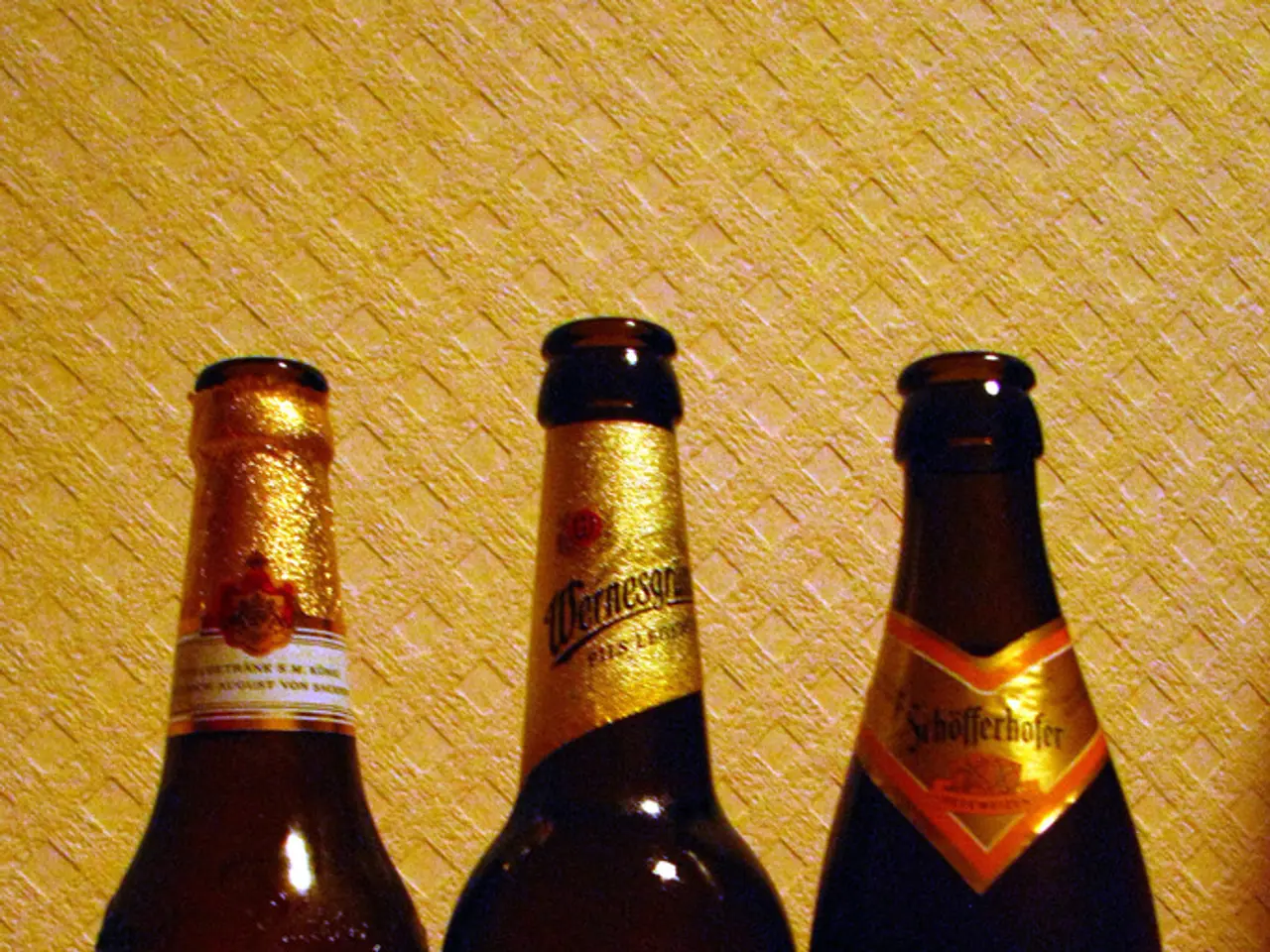 In this image there are three bottles with three different labels on the bottle.