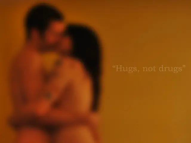 As we can see in the image there is a wall, two people and table. On table there is a bottle, box...