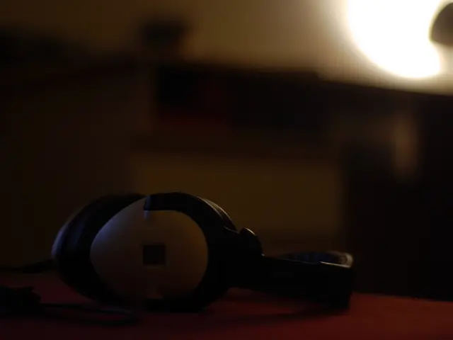 There is a headphones on a surface. In the background it is blurred.