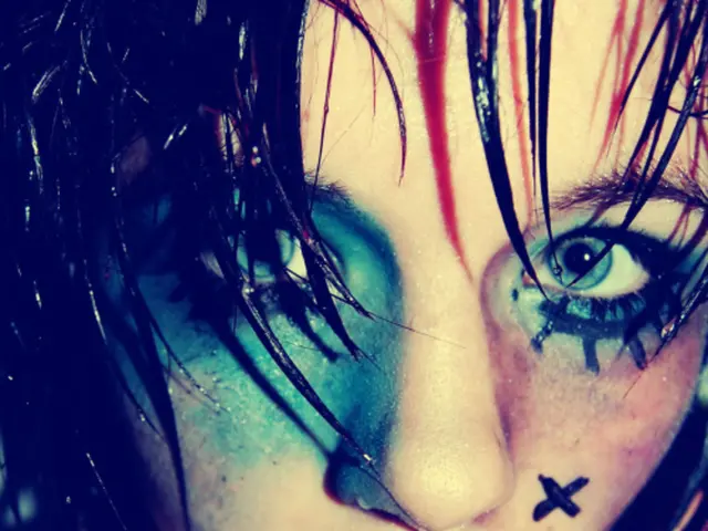 In this picture there is an image of a woman having few color marks on her face.