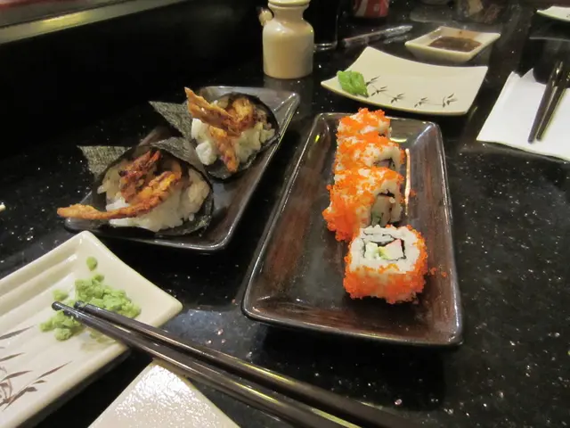 In this image, we can see planets on the table contains some food. There are chopsticks at the...