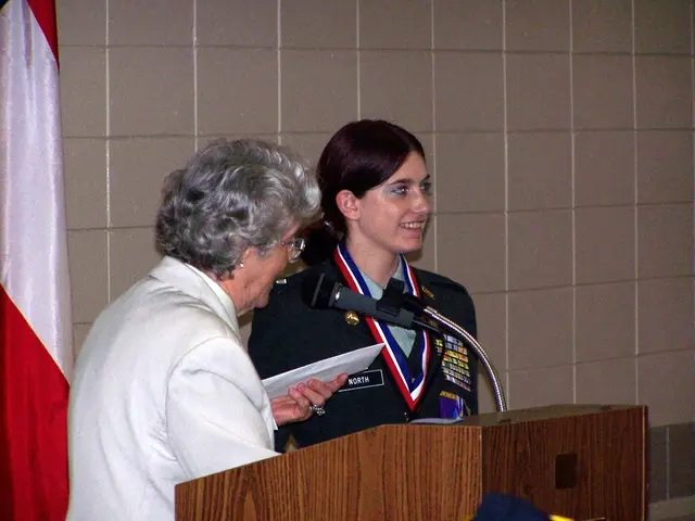 In this image I can see two women and I can see one of them is wearing uniform. In the front of...