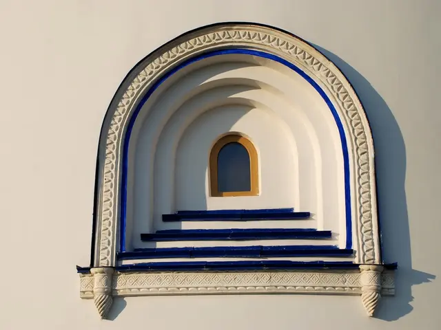 There is an arch window on a wall.
