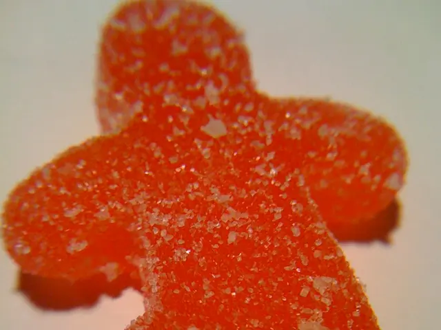In this image there is a candy coated with sugar.