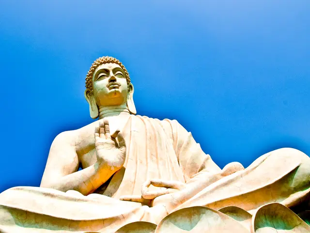 In the picture there is a sculpture of a meditating idol.
